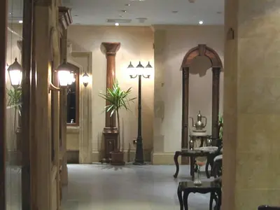 a lobby with a table and chairs in a building at Philippe Luxor Hotel in Luxor
