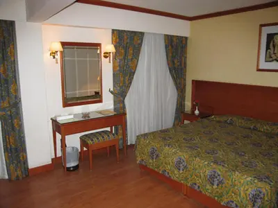 a hotel room with a bed and a desk at Philippe Luxor Hotel in Luxor