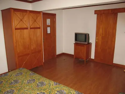 an empty room with a bed and a television at Philippe Luxor Hotel in Luxor
