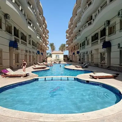 a swimming pool in the middle of a building at Nour Plaza Hurghada Studio Sea view in Hurghada