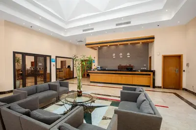 a living room with two couches and a table at Sky View Suites Hotel in Hurghada