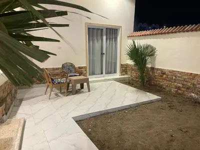 a patio with a table and chairs next to a building at El Mesala Hotel in Luxor