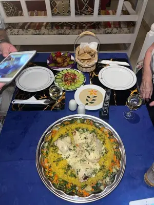 a blue table with a plate of food on it at El Mesala Hotel in Luxor