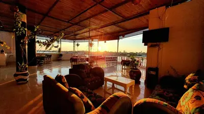 a living room with couches and a television in a building at El Mesala Hotel in Luxor