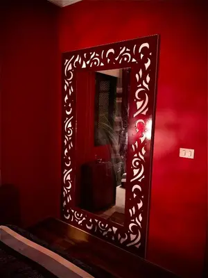 a mirror in a red room with a red wall at The View Apartment in Hurghada