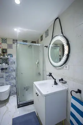 a bathroom with a shower and a sink and a mirror at The View Apartment in Hurghada