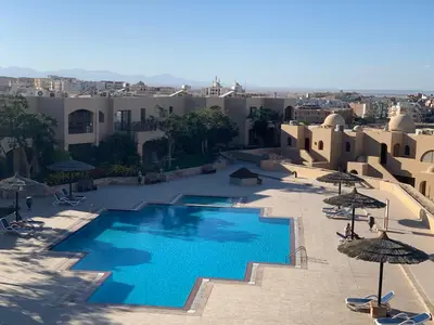 an aerial view of a swimming pool with umbrellas at The View Apartment in Hurghada