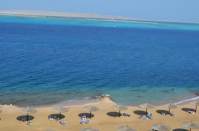 an aerial view of a beach with umbrellas and the ocean at The View Apartment in Hurghada