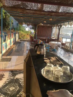 a table with glasses and a tea kettle on a counter at Awi Guest House in Aswan