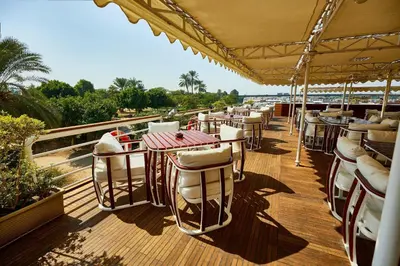 a row of tables and chairs on a deck at Sonesta St George Nile Cruise - Aswan to Luxor 3 Nights from Friday to Monday in Aswan