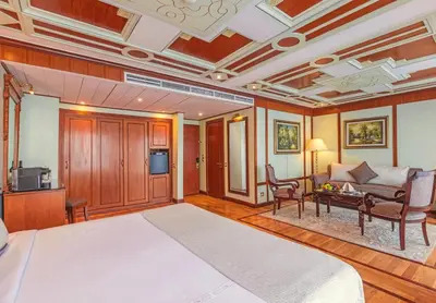 a large bedroom with a large bed and a couch at Sonesta St George Nile Cruise - Aswan to Luxor 3 Nights from Friday to Monday in Aswan