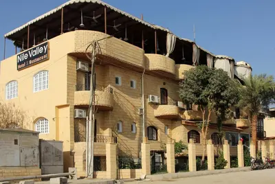 a building with baskets on the side of it at Nile Valley Hotel in Luxor