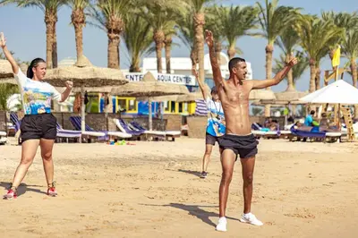 two people playing with a frisbee on the beach at Palm Royale Resort - Soma Bay in Hurghada