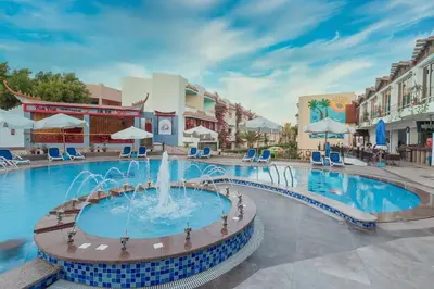 a pool at a resort with a fountain at MinaMark Beach Resort for Families and Couples Only in Hurghada