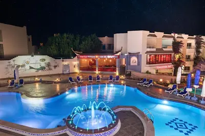 a pool at a hotel at night at MinaMark Beach Resort for Families and Couples Only in Hurghada