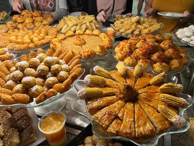 a table with many different types of food on it at Mirage Bay Resort & Aqua Park in Hurghada