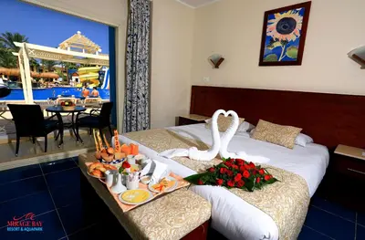 a hotel room with a bed with a swan on it at Mirage Bay Resort & Aqua Park in Hurghada