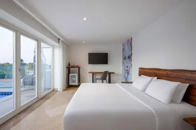 a bedroom with a white bed and a large window at Steigenberger Pure Lifestyle (Adults Only) in Hurghada
