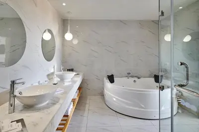 a bathroom with two sinks and a tub and a shower at Steigenberger Pure Lifestyle (Adults Only) in Hurghada
