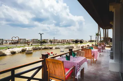 a restaurant with tables and a pond with a water park at Tropitel Sahl Hasheesh in Hurghada