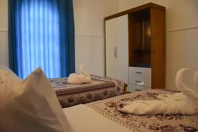a bedroom with two beds with towels on them at Villa Sunrise in Luxor