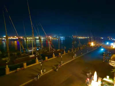 a dock at night with the water and boats at Villa Sunrise in Luxor