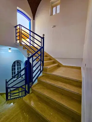 a staircase in a house with blue railings at Villa Sunrise in Luxor