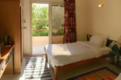 a bedroom with a bed and a large window at New Memnon Hotel in Luxor