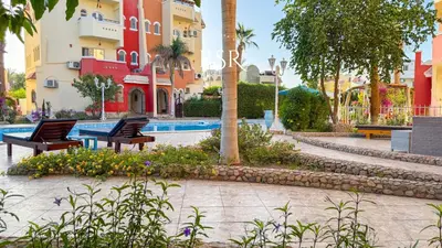 a resort with two chairs and a swimming pool at Green Garden Resort in Hurghada