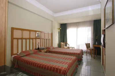 a hotel room with two beds and a window at Sea Garden Hotel in Hurghada