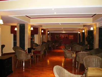 a room filled with chairs and tables and a room with wood floors at Sea Garden Hotel in Hurghada