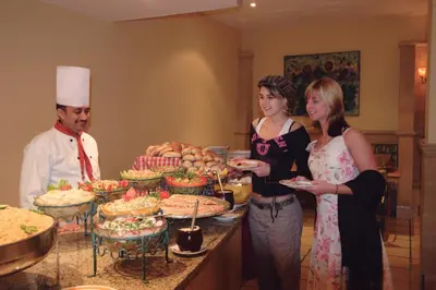 a group of people standing in front of a buffet of food at Sea Garden Hotel in Hurghada