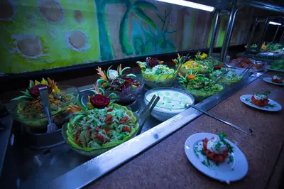 a buffet line with bowls of food and plates of food at Le Pacha Resort in Hurghada
