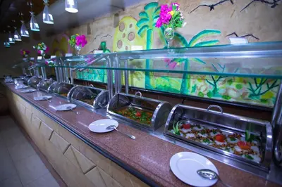 a buffet line with many trays of food at Le Pacha Resort in Hurghada