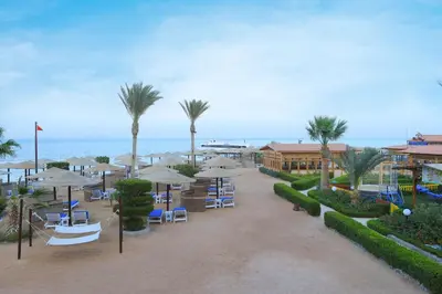 a resort with chairs and umbrellas and the ocean at Sea Star Beau Rivage Hotel in Hurghada