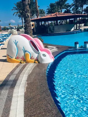 a pool with alatable elephant next to a swimming pool at Sea Star Beau Rivage Hotel in Hurghada