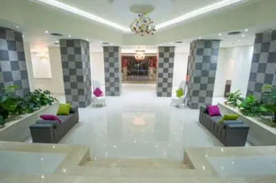 a lobby with couches and a chandelier in a building at Sun & Sea Hotel and Aqua Park - Hurghada in Hurghada