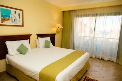 a bedroom with a large bed and a window at Sun & Sea Hotel and Aqua Park - Hurghada in Hurghada