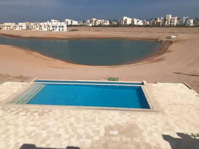 a swimming pool on the roof of a building at Joubal Apartment in Hurghada