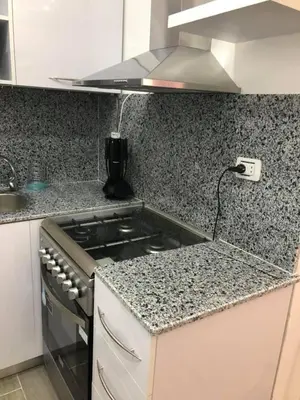 a kitchen with a stove and a counter top at Joubal Apartment in Hurghada