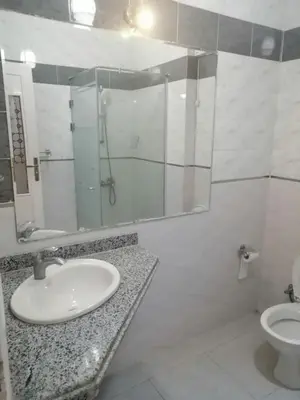 a bathroom with a sink and a mirror and a toilet at Royal City Hotel in Hurghada