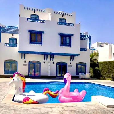 a house with a swimming pool with two inflatable ducks at Luxury Villa with pool in Hurghada in Hurghada