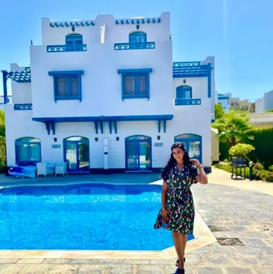 a woman in a dress standing in front of a house at Luxury Villa with pool in Hurghada in Hurghada