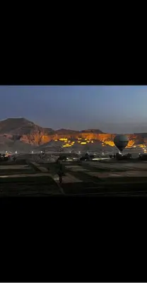 a hot air balloon in a field at night at Shahhat House in Luxor