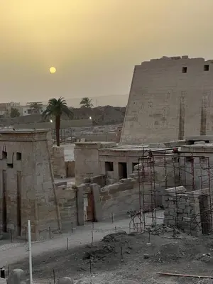 a building under construction with the moon in the background at Shahhat House in Luxor