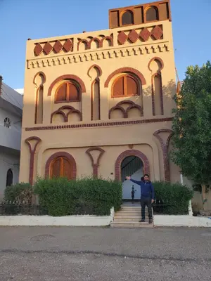 a man standing in front of a building at Shahhat House in Luxor