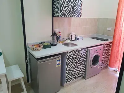 a kitchen with a sink and a washing machine at Tiba Resort Hurghada in Hurghada