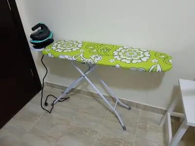 a table with a green and white cushion on it at Tiba Resort Hurghada in Hurghada