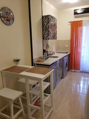 a kitchen with a table and a counter top at Tiba Resort Hurghada in Hurghada
