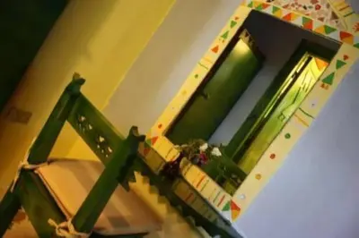 a balcony with a green railing and a window at Nubian oasis hotel in Aswan